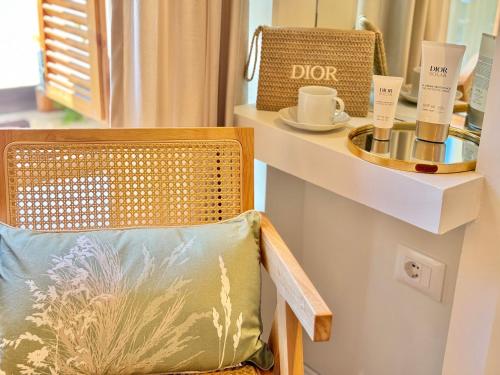 a chair with a pillow next to a counter with a table at Old Town Suites Muradie in Vlorë