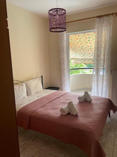 a bedroom with a bed with two towels on it at Stella's Apartment in Alexandroupoli