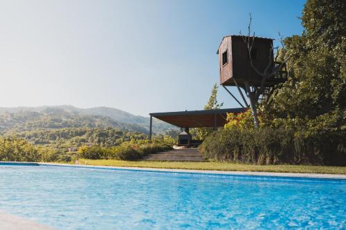 a house next to a swimming pool with a building at Casa da Mouta - Douro Valley in Baião
