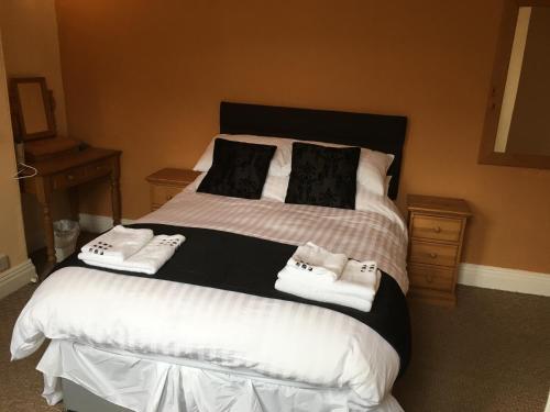 a bedroom with a large bed with two pillows at Spaview in Bridlington