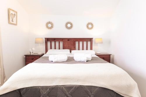 a bedroom with a large bed with two pillows at Casa Borda da Rocha in Nordeste
