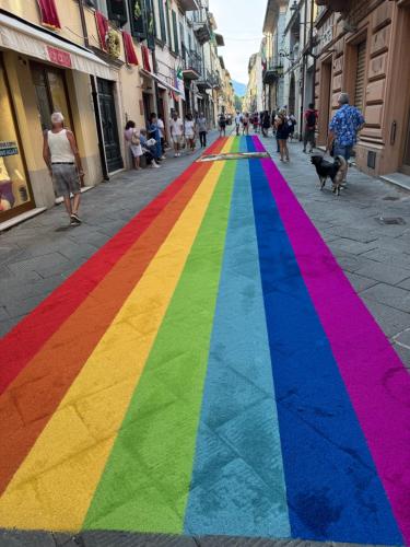 a rainbow colored sidewalk in the middle of a street at L'ARCO E' DI FIO in Camaiore