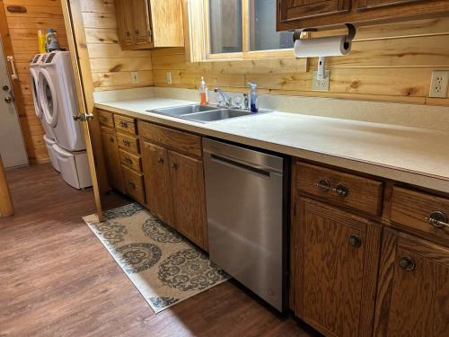 a kitchen with a sink and a dishwasher at Rio Grande Lodge in South Fork
