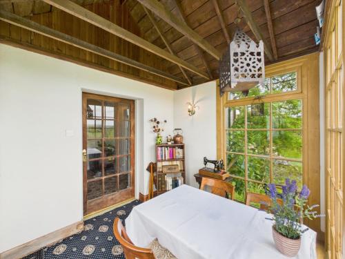 a dining room with a table and a window at Priestrig Cottage in Hawick