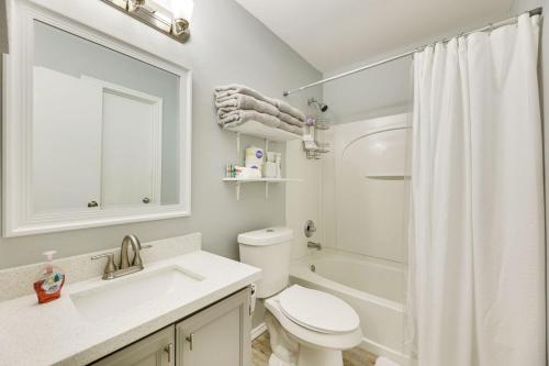 a white bathroom with a toilet and a sink at Fenced Yard and Grill - San Juan Vacation Rental in San Juan