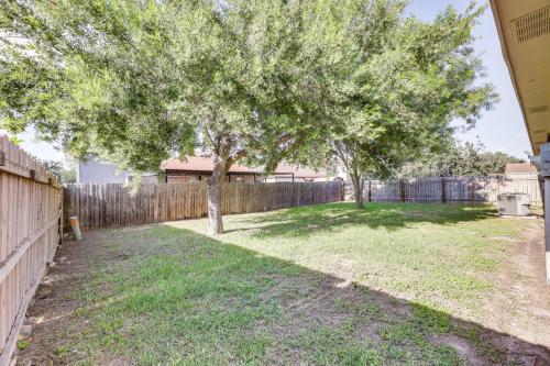 a yard with a fence and two trees at Fenced Yard and Grill - San Juan Vacation Rental in San Juan