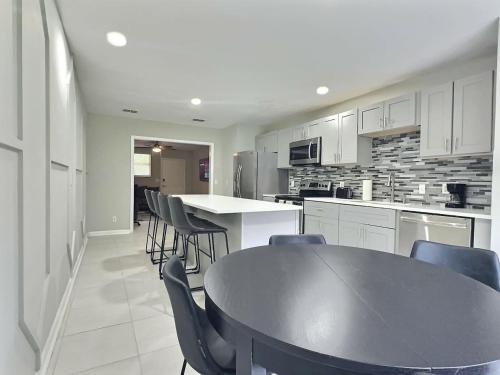 a kitchen with a black table and chairs in it at Conant Gray in Jacksonville