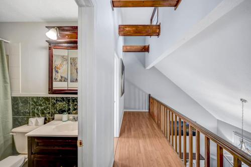 a bathroom with a sink and a staircase at Pocono Chalet Towamensing with Hot Tub Lake and Pool in Albrightsville