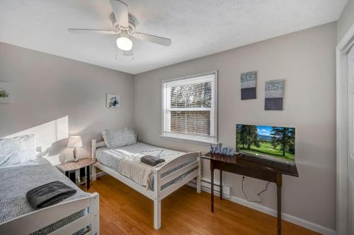 a bedroom with a bed and a flat screen tv at Pocono Chalet Towamensing with Hot Tub Lake and Pool in Albrightsville