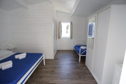 a small room with two beds and a window at Aquarius Policoro in Policoro