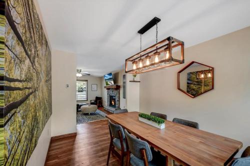 a dining room with a wooden table and chairs at Lakefront home with kayaks fire pit hot tub and walk to restaurants and bars in Lake Harmony