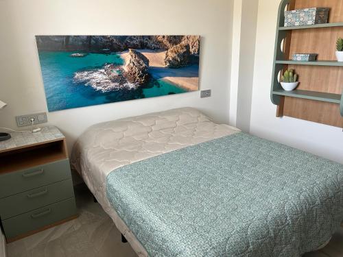 Un dormitorio con una cama y un cuadro en la pared. en Casa La Pita, en El Pozo de los Frailes