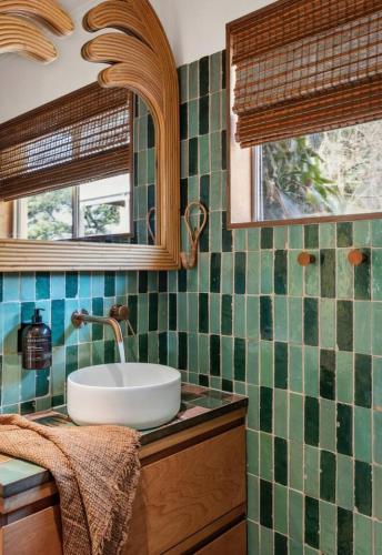 a bathroom with a sink and a mirror at Sundowner Suite No. 2 in Yamba