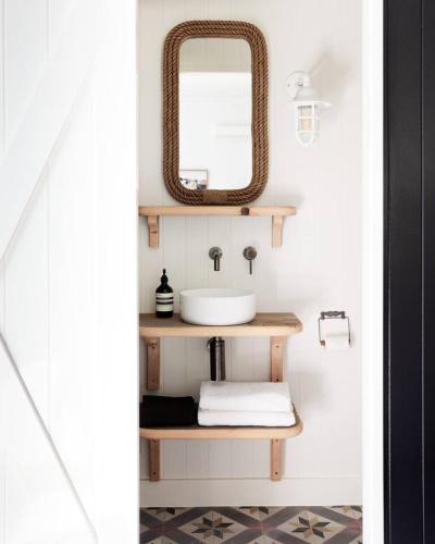 a bathroom with a sink and a mirror at The Black Ace Yamba in Yamba