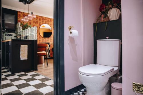 a bathroom with a white toilet in a room at 70s Hideaway Guest Studio for 2 I Private I Self Contained I Near Cardiff in Cardiff