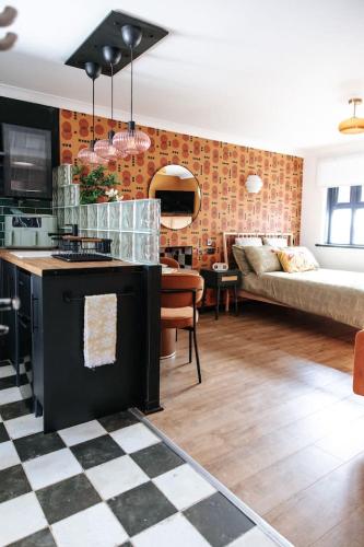 a kitchen and a living room with a couch at 70s Hideaway Guest Studio for 2 I Private I Self Contained I Near Cardiff in Cardiff