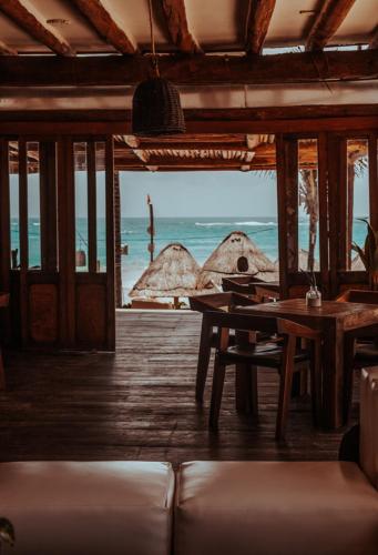 a room with a table and a view of the ocean at Niken Beachfront Tulum Hotel in Tulum