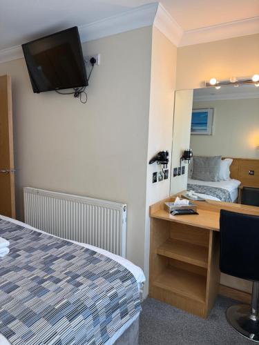 Ένα ή περισσότερα κρεβάτια σε δωμάτιο στο Granada Apartments Queens Mansions