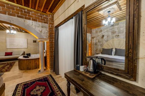 a bedroom with a bed and a tub in a room at Soho Cappadocia in Goreme