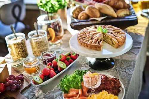 a table with plates of different types of food at Stangeland Gard in Austevoll