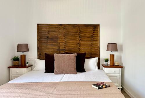 a bedroom with a bed with a wooden headboard at Canaryislandshost l Olympica in Teguise