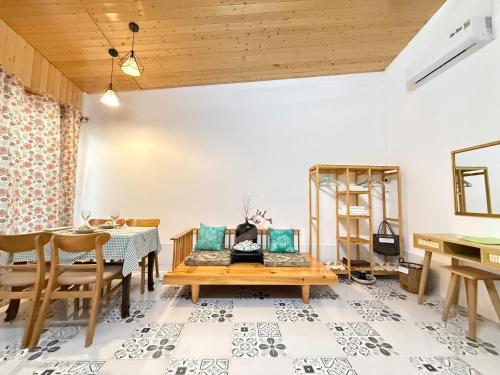 a dining room with a table and chairs and a wooden ceiling at Bình An Village 