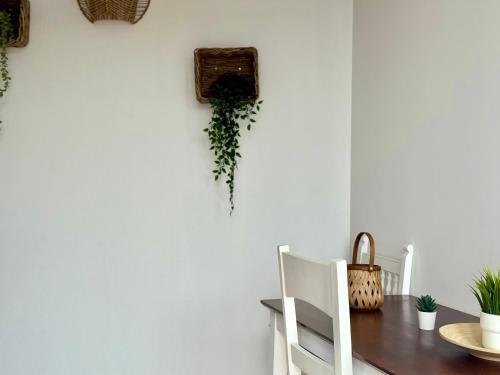 a dining room with a table and a white wall at Canaryislandshost l Olympica in Teguise