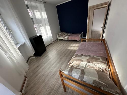 a bedroom with two beds in a room at Apartament Arpika in Ząbkowice Śląskie