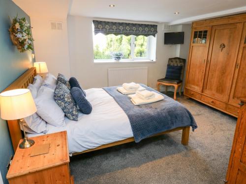 a bedroom with a bed with two towels on it at The Thyme House in Keighley