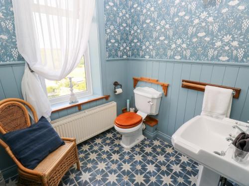 a bathroom with a toilet and a sink at The Thyme House in Keighley