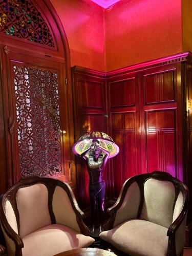 a room with two chairs and a table and a lamp at Zalagh Parc Palace in Fès