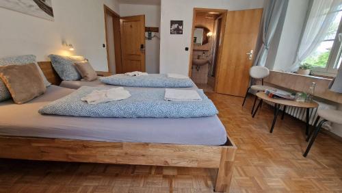 a bedroom with two beds with towels on them at Alpen Hotel Martin in Nesselwang