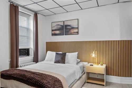 a bedroom with a large bed and a window at Modern Studio - Parking Available - 15 min NYC in Jersey City