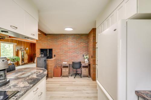 a kitchen with white cabinets and a brick wall at 11 Mi to Maple Lake 5-Acre Property in Fertile! 