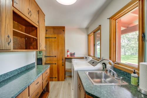 a kitchen with wooden cabinets and a sink at 11 Mi to Maple Lake 5-Acre Property in Fertile! 