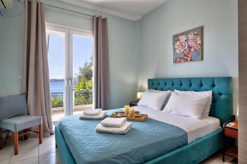 a bedroom with a bed and a large window at Villa Violeta Lefkada Nydri in Nydri