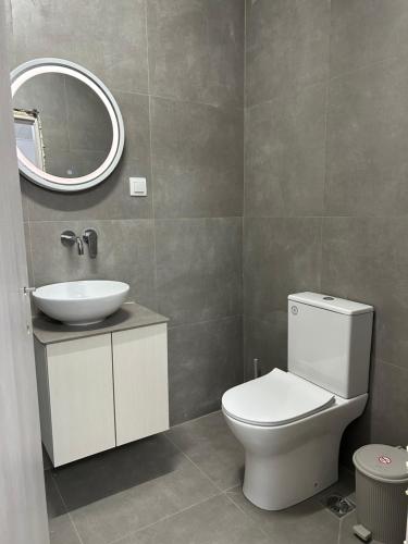 a bathroom with a toilet and a sink and a mirror at Soleil House in Kallirakhi