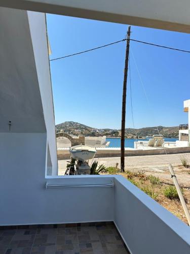 a view from the balcony of a house with a window at Rena's Garden Rooms in Lipsoi