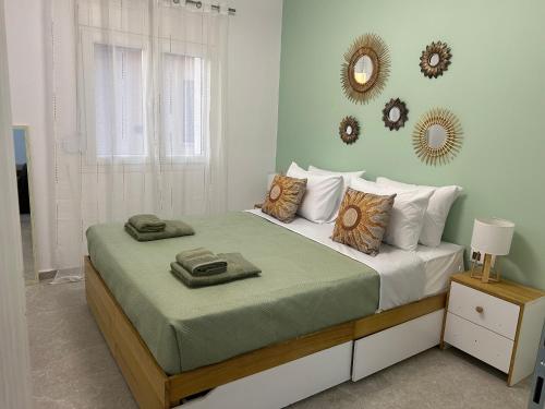 a bedroom with a large bed with pillows and a mirror at Soleil House in Kallirakhi