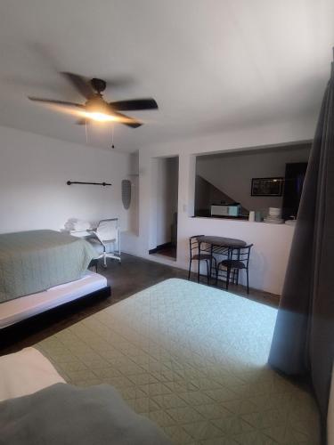 a bedroom with a bed and a table with chairs at DGM Lofts MTY MN 960 G centro cerca de todo in Monterrey