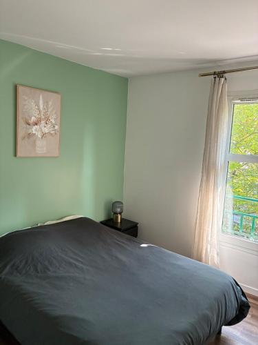 a bedroom with a bed and a window at Cosy Disney Escape - 3 min Disney - 35 min Paris in Chessy