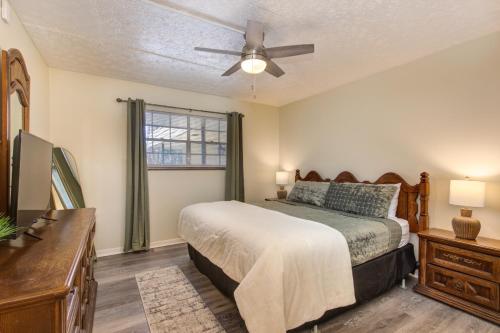 a bedroom with a bed and a ceiling fan at Roaring Fork Road Retreat By Avada Properties in Gatlinburg