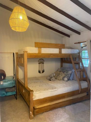 a bedroom with two bunk beds and a chandelier at Cabernet Cabaña - La Cava Lodge in Medellín