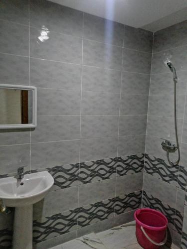 a bathroom with a sink and a shower at Aicha appartement 2 in Meknès