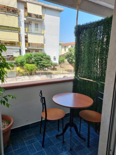 a table and two chairs on a balcony at Pagani Urban Stay in Pagani