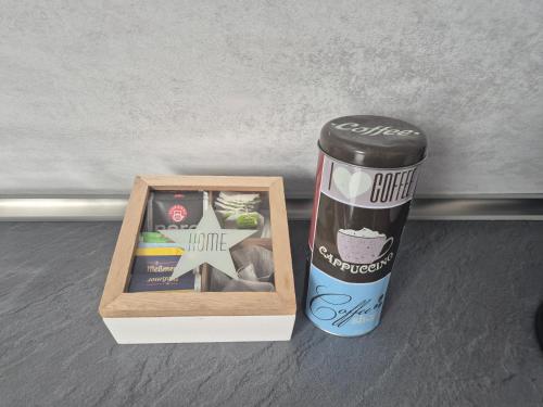a can of coffee next to a container of food at Schumacher Ferienwohnung in Netphen