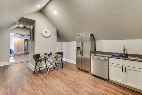 a kitchen with a table and a clock on the wall at Walk to River and Downtown Portsmouth Apartment! in Portsmouth