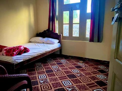 a small room with a bed and a window at K6 Hotel & Camping Kande in Kande