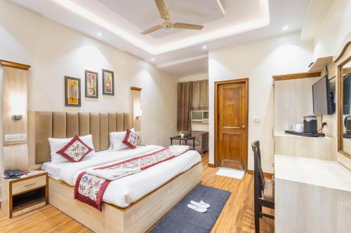 a hotel room with a bed and a television at Hotel Garden View - Near Karol Bagh Metro Station and Gaffar Market in New Delhi