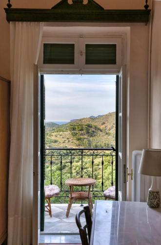 a door leading to a balcony with a view at Archontiko Lastros in Lástros